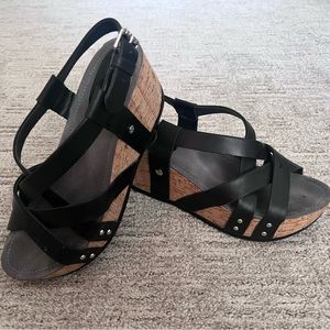 Bussola black wedge sandals with silver accents.